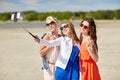 Group of smiling women taking selfie on beach Royalty Free Stock Photo