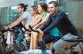 Group smiling  working out of cycling in  fitness club Royalty Free Stock Photo