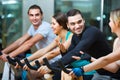 Group smiling working out of cycling in fitness club Royalty Free Stock Photo