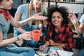 Group of smiling young women drinking coffee and studying together Royalty Free Stock Photo