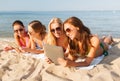 Group of smiling young women with tablets on beach Royalty Free Stock Photo