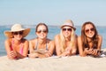 Group of smiling young women with tablets on beach Royalty Free Stock Photo