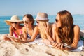 Group of smiling young women with tablets on beach Royalty Free Stock Photo