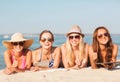 Group of smiling young women with tablets on beach Royalty Free Stock Photo