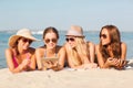 Group of smiling young women with tablets on beach Royalty Free Stock Photo