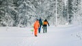 Group of snowboarders goes along the path up the hill on a snowy winter forest. Extreme sports. Holidays in the mountains. WEB