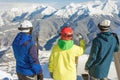 Group of snowboarders and skier at summit