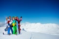 Group of snowboarders stand together over mountain