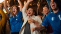 Group of Soccer Fans with Colored Faces Watching a Live Football Match in a Sports Bar. People Royalty Free Stock Photo