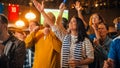 Group of Soccer Fans with Colored Faces Watching a Live Football Match in a Sports Bar. People Royalty Free Stock Photo