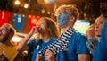 Group of Soccer Fans with Painted Faces Cheering, Screaming, Raising Hands and Jumping During a Royalty Free Stock Photo