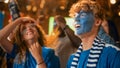 Group of Soccer Fans with Painted Faces Cheering, Screaming, Raising Hands and Jumping During a Royalty Free Stock Photo