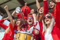 Group of soccer fans watching a sports event in the stands of a stadium Royalty Free Stock Photo