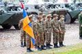 A group of soldiers of the Armenian army in hygienic masks with the flag of the Republic of Armenia on the background of military