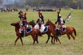 Group of soldiers-reenactors ride horses.