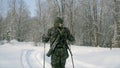 Group of soldiers run on skis in the woods with weapons. Clip. Soldiers with AK-47 rifles and grenade launchers running Royalty Free Stock Photo