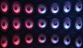 Group of sound speakers in neon light.