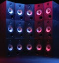 Group of sound speakers in neon light on black.