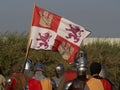 Group of Spanish medieval knights holding Spanish royal flag Royalty Free Stock Photo