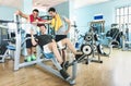 Group of sportive friends using mobile phone at gym fitness club Royalty Free Stock Photo