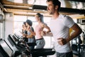 Group of sportive people in a gym. Concepts about lifestyle and sport in a fitness club