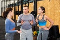 Group of sports enthusiasts talking friendly during break in workout Royalty Free Stock Photo