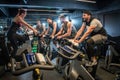 Group of sporty men looking at female instructor during spinning class in gym. Royalty Free Stock Photo