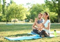 Group of sporty people practicing yoga in park Royalty Free Stock Photo