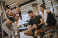 Group of sporty people in sportswear taking selfie photo with mobile phone at gym