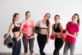 Group sporty woman with yoga mats standing