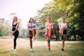Group of sporty young women doing workout at public park in the morning,Slim woman warming up body at outdoor Royalty Free Stock Photo