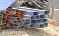 Group of square steel rectangle tubes metal iron production profiles pipe on the ground. Square metal pipes for background using Royalty Free Stock Photo