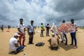 A group of Sri Lankan men with a kite on Negombo beach in Sri Lanka.