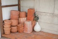 Group of stacked clay pot and flower vase in shelf