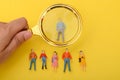 The group of staff, armed with a magnifying glass, scoured the job applications, searching for the ideal candidate to hire