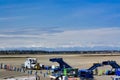 A group of stairs and ground service vehicles on a runway at Seattle-Tacoma International Airport