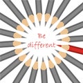 A group of standard grey pencils and one red with motto - be different