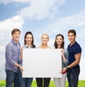 Group of standing students with blank white board Royalty Free Stock Photo