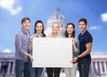 Group of standing students with blank white board Royalty Free Stock Photo