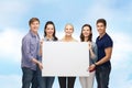 Group of standing students with blank white board Royalty Free Stock Photo