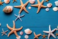 a group of starfish and other sea shells on a blue surface with a blue background and a white border Royalty Free Stock Photo