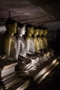 The group of statues of the Buddha in the Lotus position in a cave temple in Dambulla