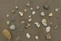Group of stones of different colors and textures on an empty beach during the day