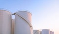 Group of storage fuel tanks in oil industrial manufacturing area against clear sky background in evening time Royalty Free Stock Photo