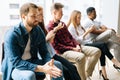 Group of stressed young diverse multi-ethnic job candidates in casual clothes waiting interview with hr, sitting in