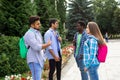 Group of studens stand with backpacks at the campus and discuss lessons Royalty Free Stock Photo