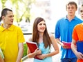 Group student with book outdoor.