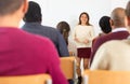 Group of students attentively listening to lecture of female teacher Royalty Free Stock Photo