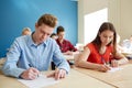 Group of students with books writing school test