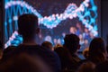 A group of students is captivated by a large screen displaying an educational film on DNA, modern technology enhances the